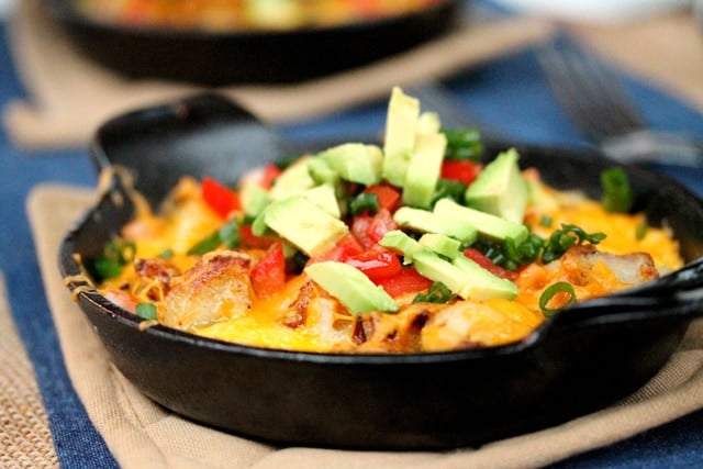 Fried Potato, Egg and Cheese Scramble with Avocado in skillet