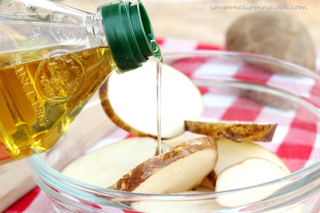Add olive oil in bowl with sliced potatoes