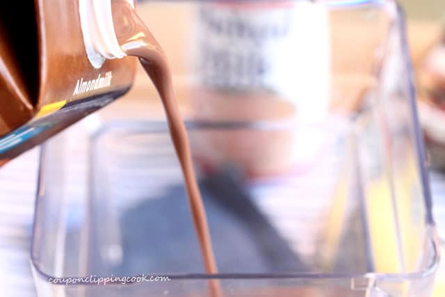 Pour almond milk in blender jar