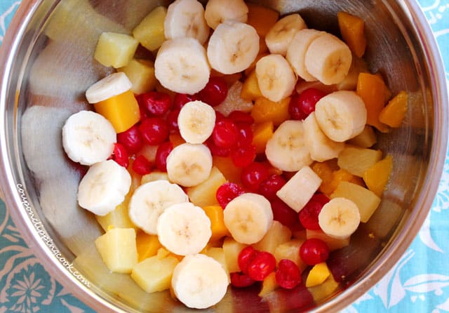 Cut cherries, mango, banana in bowl