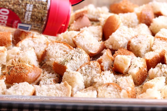 Add oregano on cut bread for croutons