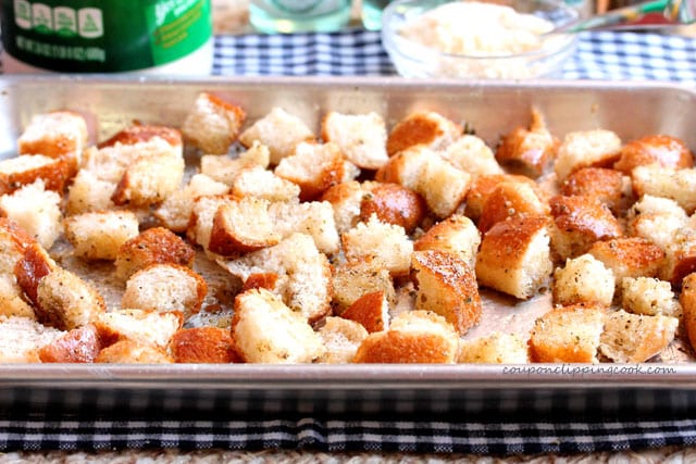 Cut pieces of bread for croutons on pan